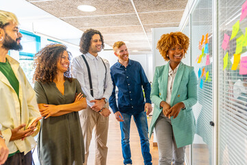 Proud young multi-ethnic people during a creative process using post-its