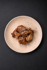Delicious grilled chicken wings with salt, spices and teriyaki sauce
