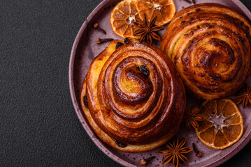Fototapeta premium Delicious baked cinnamon raisin rolls in the form of rolls