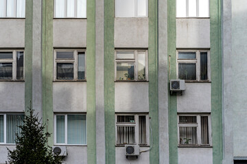 Lots of white wooden windows. Building's facade.