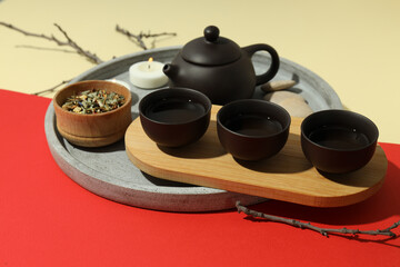Asian tea concept, traditional dishes on red background.