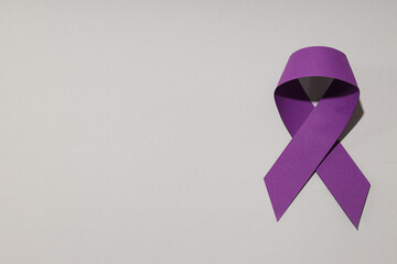 Purple ribbon, concept for the day of elimination of violence against women.