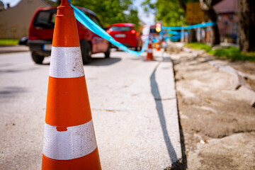 Traffic cone tied, connected, with blue warning tape