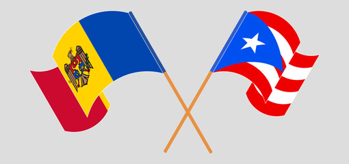 Crossed and waving flags of Moldova and Puerto Rico