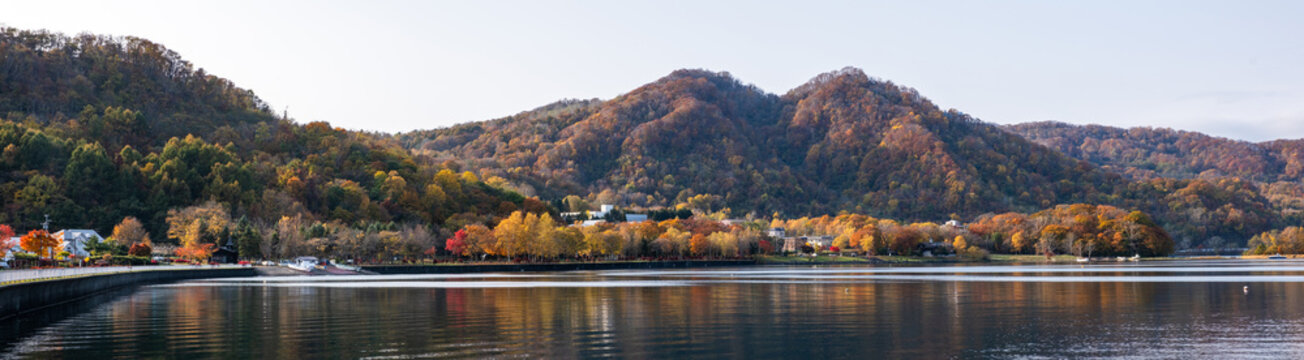 Autumn panorama view, mountainous vistas with vibrant skylines of Lake Toya in Hokkaido Japan.
