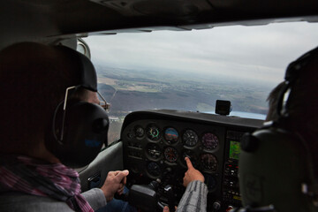 view from over snow covered peaks while flying in small plane