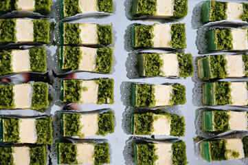Close-up of a stack of green tea cakes on a white background