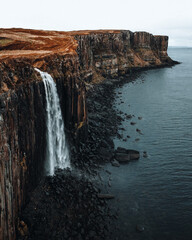 cliffs with waterfall into sea