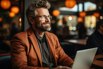 Obraz premium Project manager or experienced businessman Sitting and working on his computer or laptop happily in the office feels relieved and comfortable.