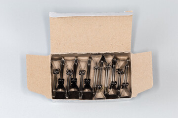 Binder clips for paper in open paperboard box, top view