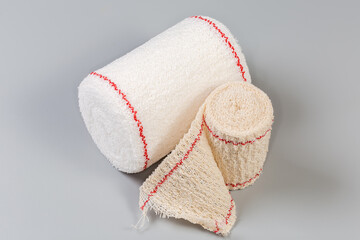 Two rolls of the woven elastic medical bandages different sizes