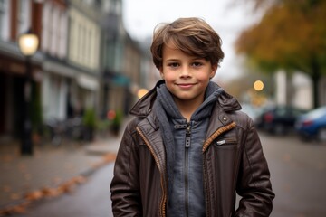 Outdoor portrait of a cute little boy in a city street.
