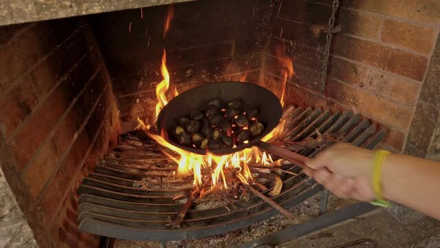 roasting chestnuts in a fireplace, fixed shot