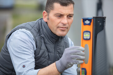 man checking regularly with a spirit level