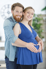 beautiful pregnant woman and husband hugging