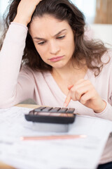 worried young single mother feeling stressed while working through finances