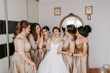The bridesmaids help the bride get dressed. Preparation for the wedding. Morning of the bride