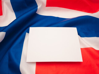 A blank white paper on the Norway flag background.