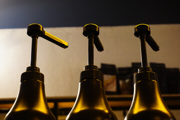 Sauce pump dispensers close up view - obrazy, fototapety, plakaty