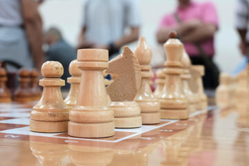 Chess wooden pieces on the board. Position on the board.