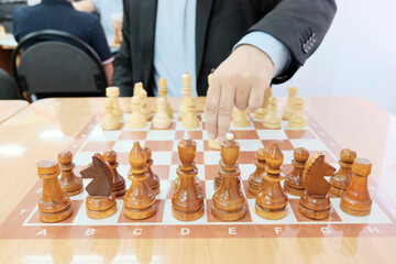 Chess wooden pieces on the board. Position on the board.