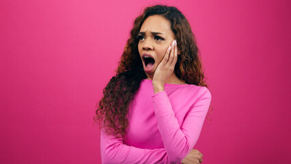 Shocked young woman hand to face, disbelief, heartbroken relationship, studio