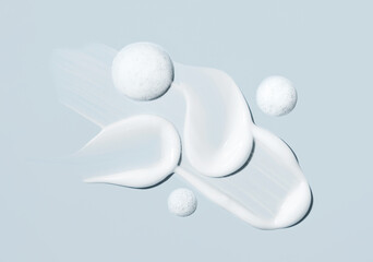 cosmetic smears of creamy texture on gray background