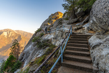 Stairs leading up to touristic viewpoint Moro Rock in Sequoia National Park during sunset. 