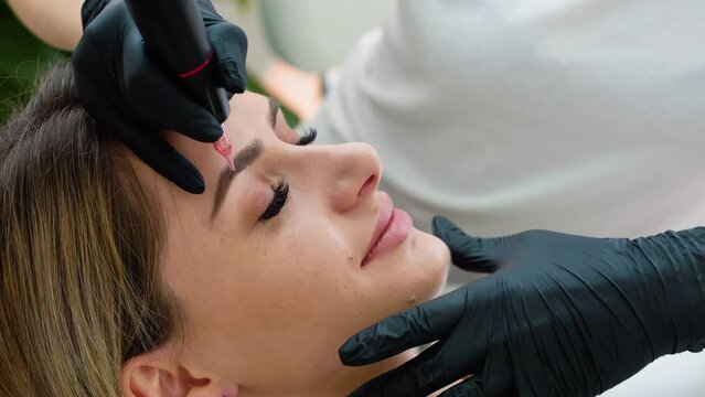 Eyebrow tattoo procedure with a permanent makeup machine