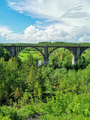 Fototapeta na wymiar Railway bridge across the river in the south of the Kama region. The old Big Sars viaduct. The abandoned Oktyabrsky viaduct in the Perm Region. Russia.