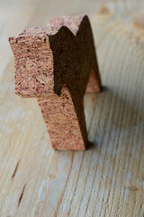 One wooden horse on the wooden background. Little wooden toy in the form of a horse on the wooden background. Brown background