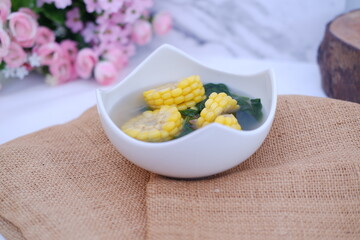 Sayur Bening Daun kelor jagung or Moringa Oleifera clear soup with sweet corn served in bowl