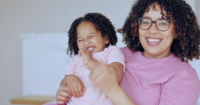 Family, love and a mother tickling her daughter in the bedroom of their home together for bonding. Portrait, smile or funny with a happy young parent and girl child laughing or having fun in bed