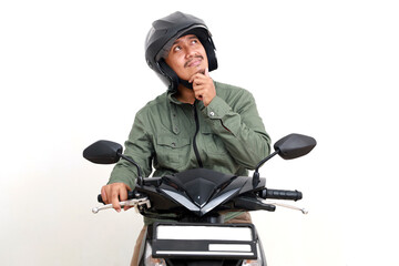 Thoughtful asian man thinking looking above while driving motorcycle. Isolated on white background