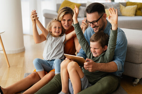 Device technology family online education concept. Happy family with digital devices at home.