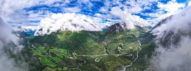 Aerial view from above the clouds  the valley of Videseter descending towards fjord in Norway