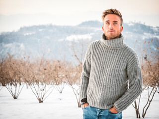 Handsome man in snow posing for camera