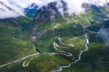 Aerial view from above the clouds  the valley of Videseter descending towards fjord in Norway