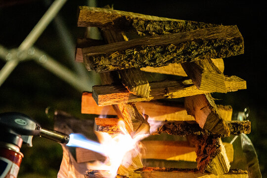 torching a wood fire in a fireplace