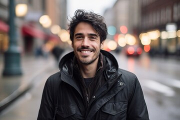 Portrait of a handsome young man in a city street smiling at the camera