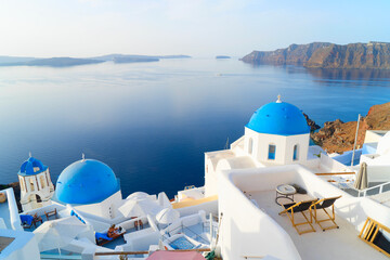 white church belfry, brigh blue domes and volcano caldera with sea landscape, beautiful details of Santorini island, Greece - obrazy, fototapety, plakaty