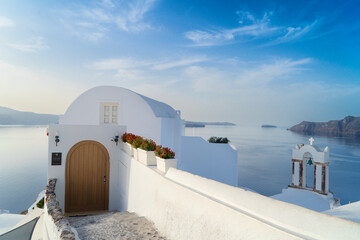 beautiful details of Santorini island, typical Santorini street with white church belfries and...