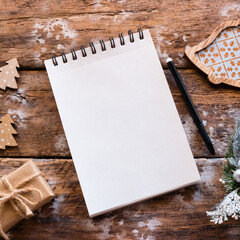 blank page of notebook for christmas letter on wooden background