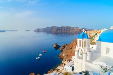 Poster famous blue domes and volcano caldera with deep sea landscape, beautiful details of Oia and Santorini island, Greece © neirfy