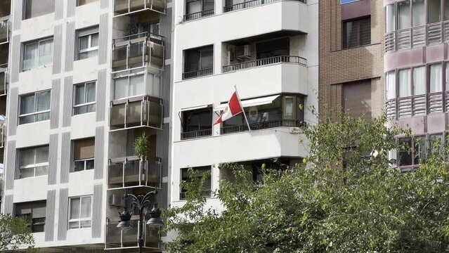 Peru flag flying on balcony of residential building in Valencia