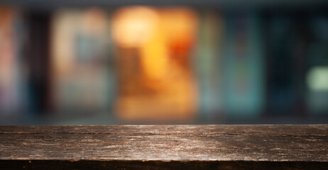 Empty wooden background for your display space. Blurred bokeh background of cafe window reflections...