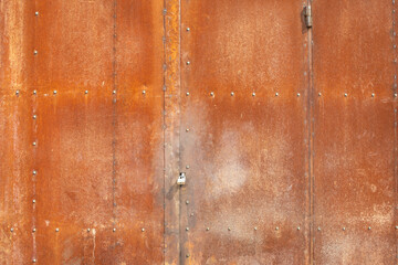 Rusty gates. Entrance to workshop. Industry in detail.