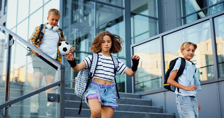 Happy friends meeting reunion on street hugging spend time together have fun relaxing resting after lessons at school. Happy children talking smiling walking outside. Group of cheerful energetic