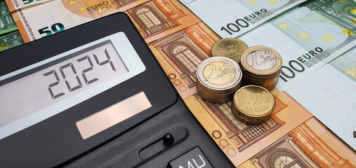 Decrease in income and salary in 2024. Calculator banknotes and euro coins. Budget, inflation,...