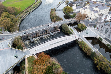 Aerial shot of Galway at rush hour featuring pedestrians and traffic.	